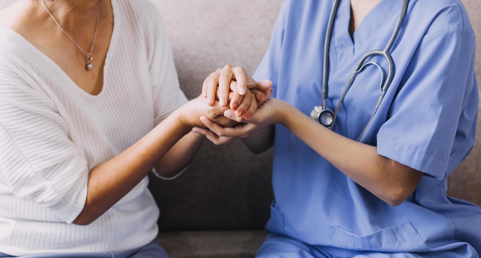 Homecare nursing service and elderly people cardiology healthcare. Close up of young hispanic female doctor nurse check mature caucasian man patient heartbeat using stethoscope during visit photo