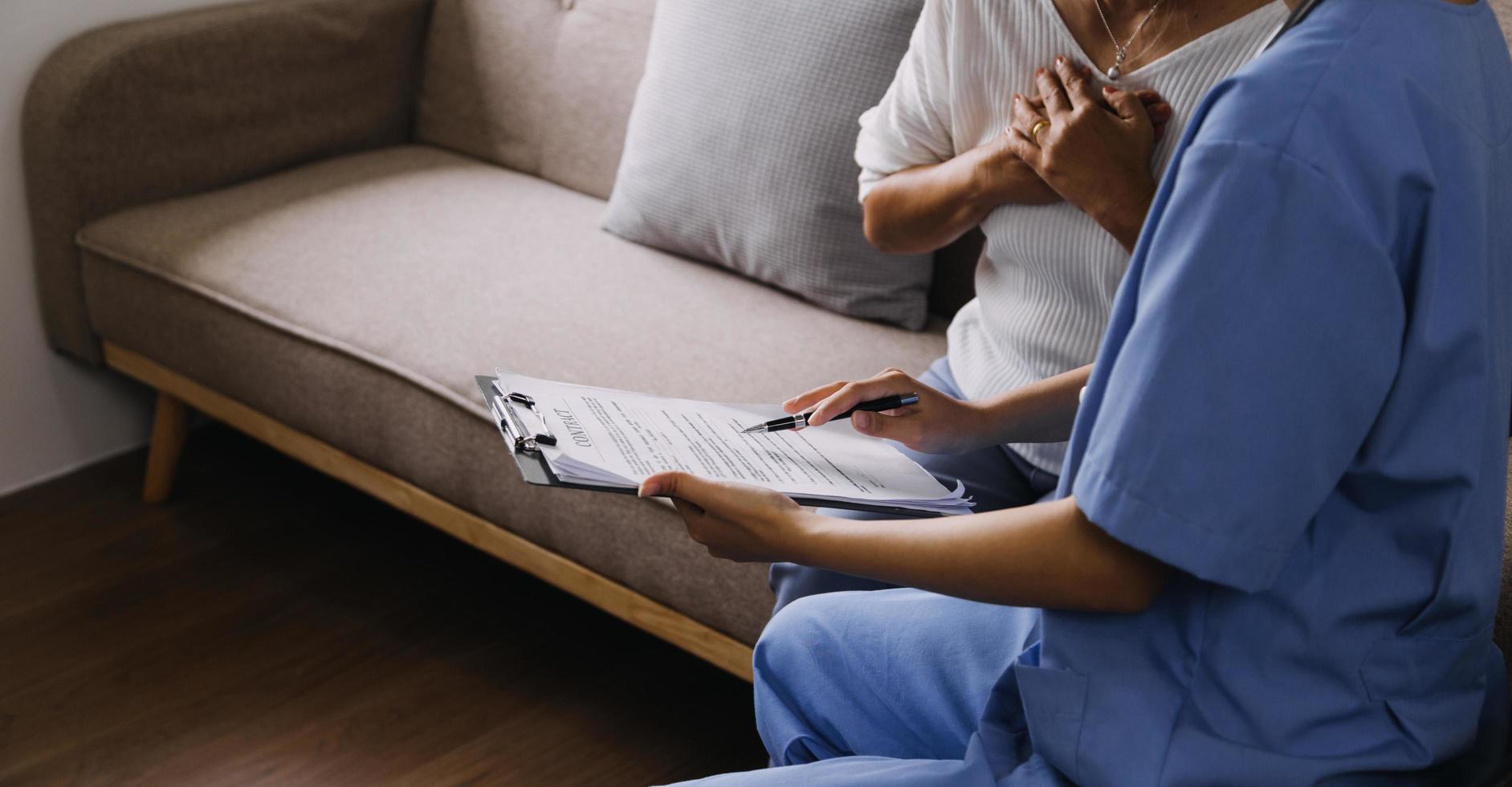 servicio de enfermería domiciliaria y cardiología asistencial a personas mayores. Primer plano de una joven doctora hispana enfermera comprobar los latidos del corazón de un hombre caucásico maduro usando un estetoscopio durante la visita foto