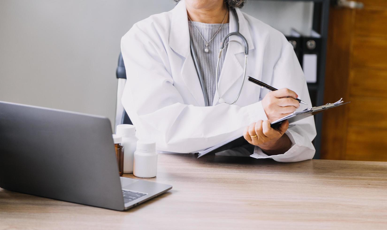 Homecare nursing service and elderly people cardiology healthcare. Close up of young hispanic female doctor nurse check mature caucasian man patient heartbeat using stethoscope during visit photo