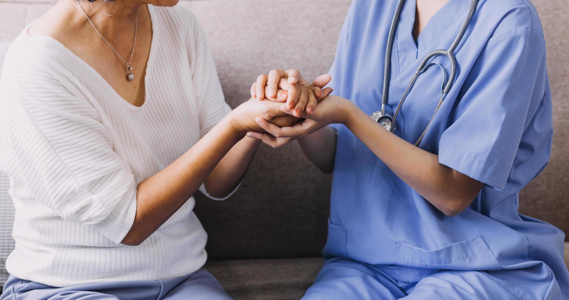 Homecare nursing service and elderly people cardiology healthcare. Close up of young hispanic female doctor nurse check mature caucasian man patient heartbeat using stethoscope during visit photo