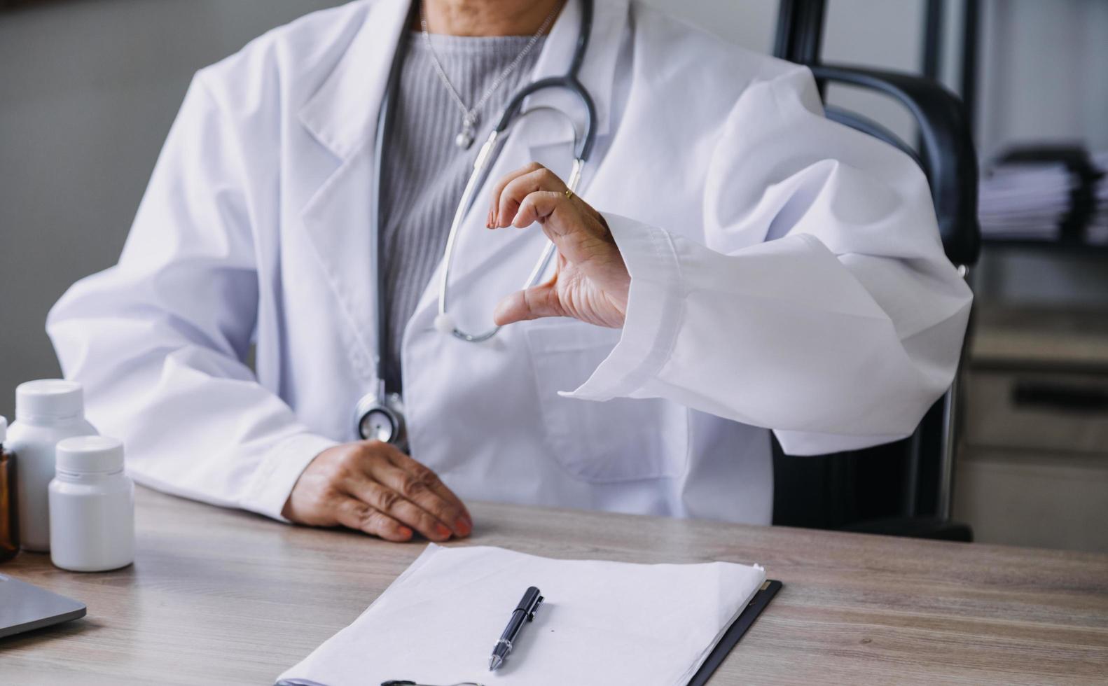 Homecare nursing service and elderly people cardiology healthcare. Close up of young hispanic female doctor nurse check mature caucasian man patient heartbeat using stethoscope during visit photo