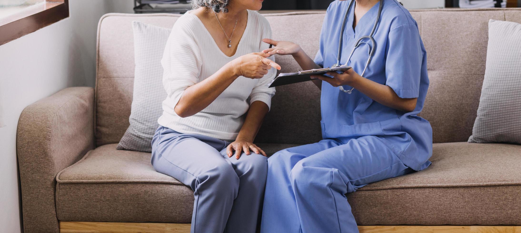Homecare nursing service and elderly people cardiology healthcare. Close up of young hispanic female doctor nurse check mature caucasian man patient heartbeat using stethoscope during visit photo