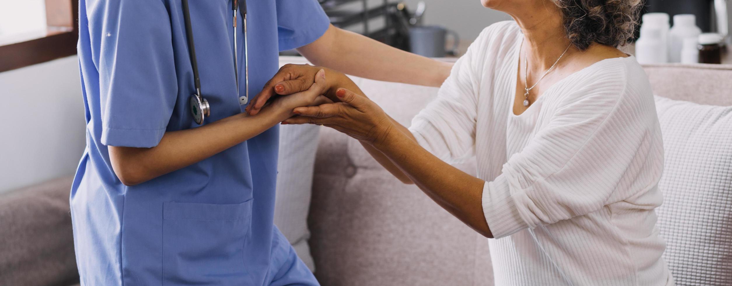 Homecare nursing service and elderly people cardiology healthcare. Close up of young hispanic female doctor nurse check mature caucasian man patient heartbeat using stethoscope during visit photo