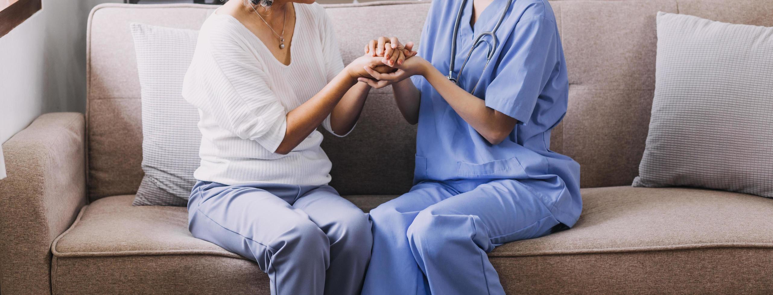 Homecare nursing service and elderly people cardiology healthcare. Close up of young hispanic female doctor nurse check mature caucasian man patient heartbeat using stethoscope during visit photo