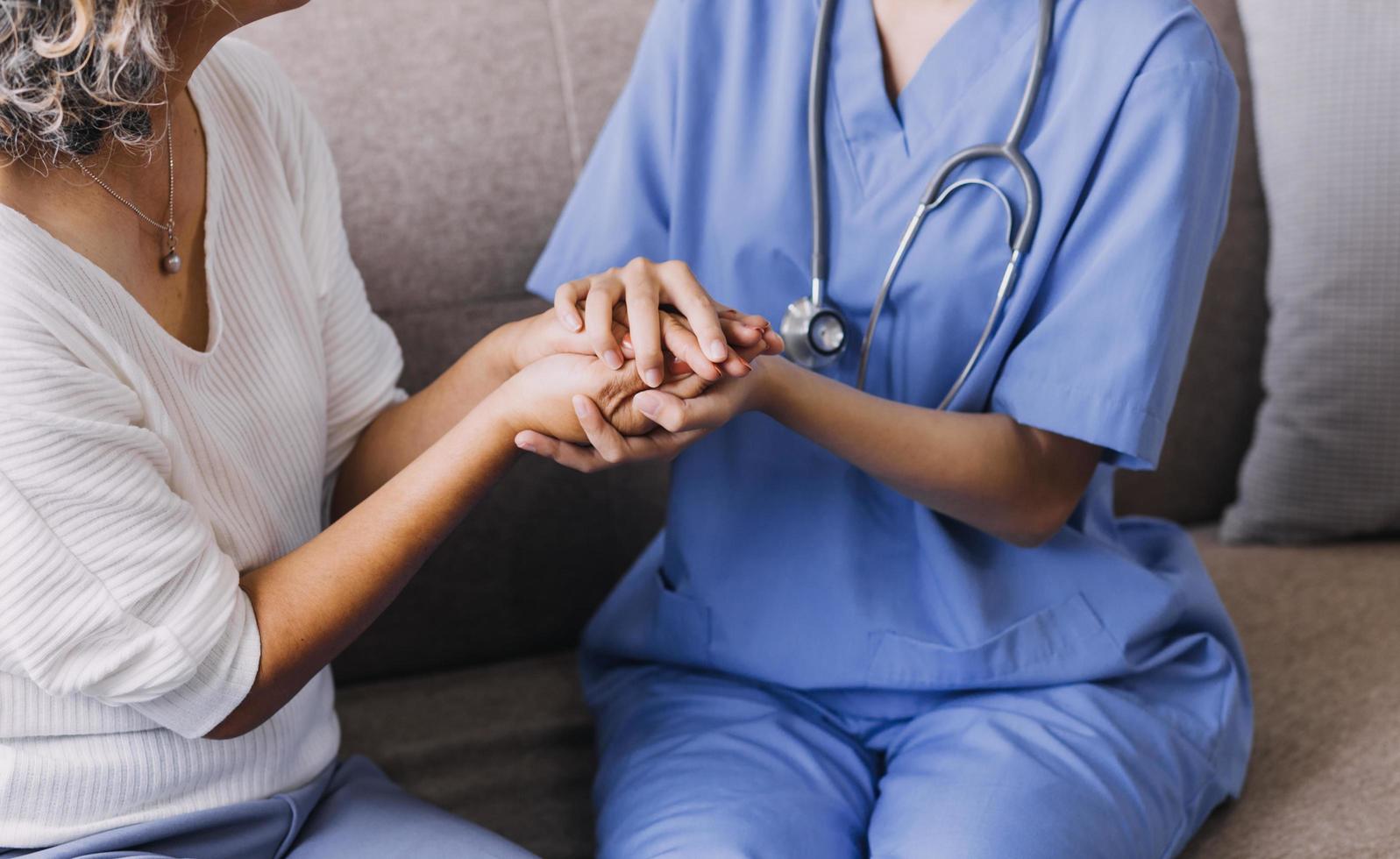 Homecare nursing service and elderly people cardiology healthcare. Close up of young hispanic female doctor nurse check mature caucasian man patient heartbeat using stethoscope during visit photo