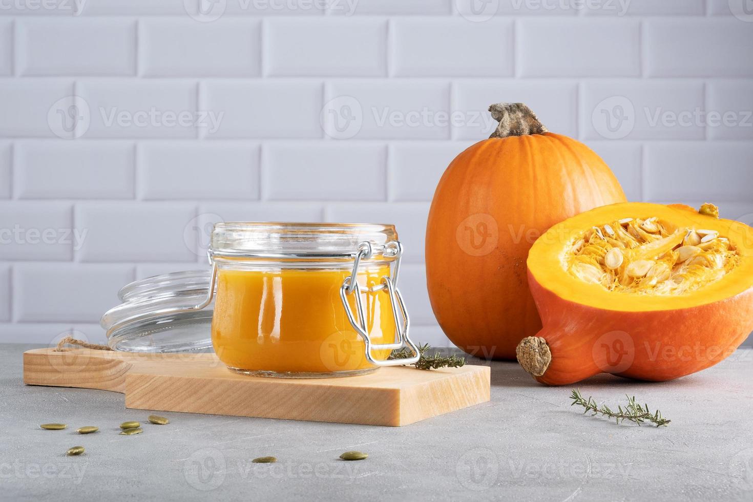 Pumpkin puree soup with pumpkin seeds and thyme photo