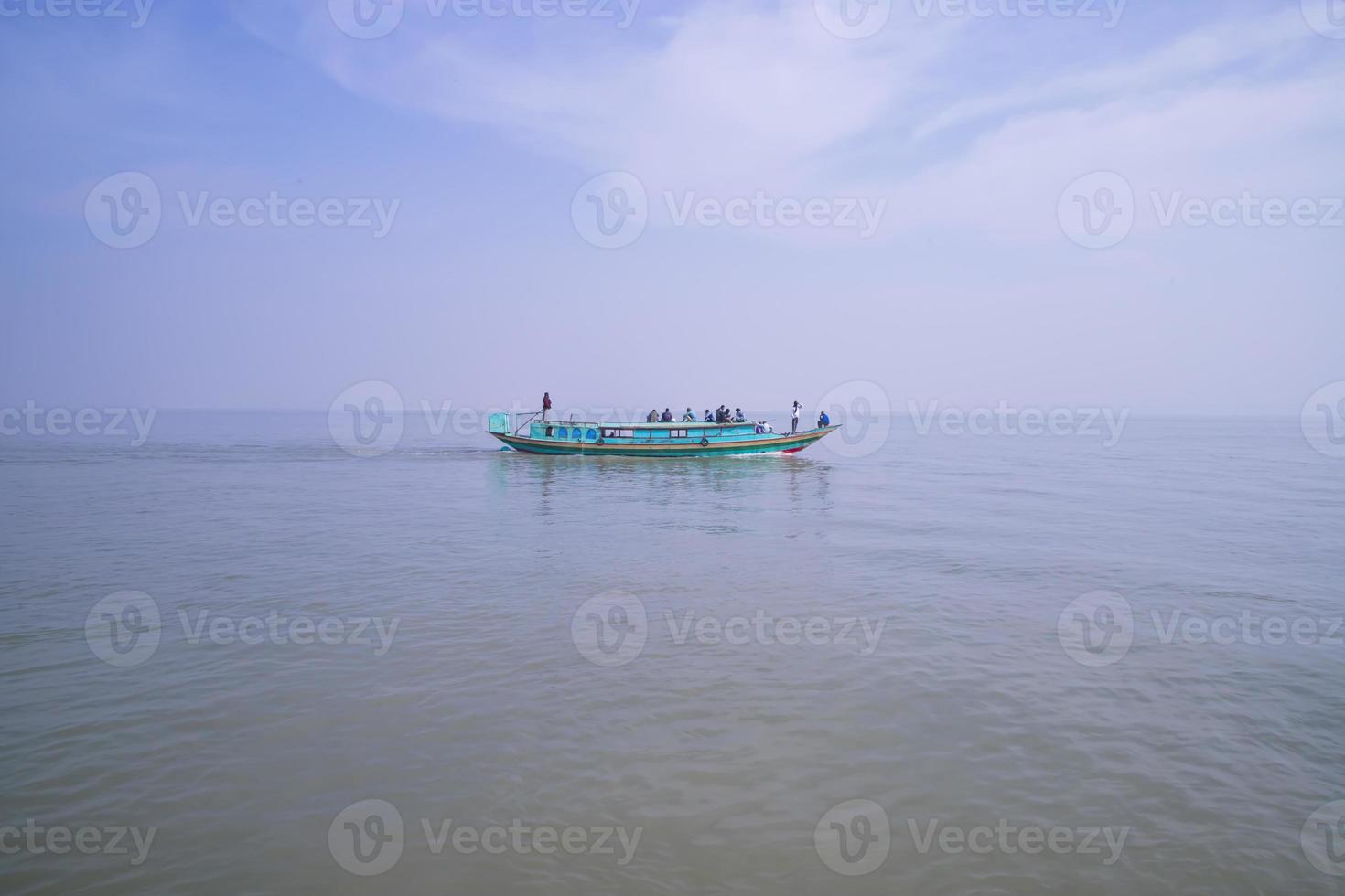 Traditional Travel Boat aginest blue sky in Padma river - Bangladesh photo