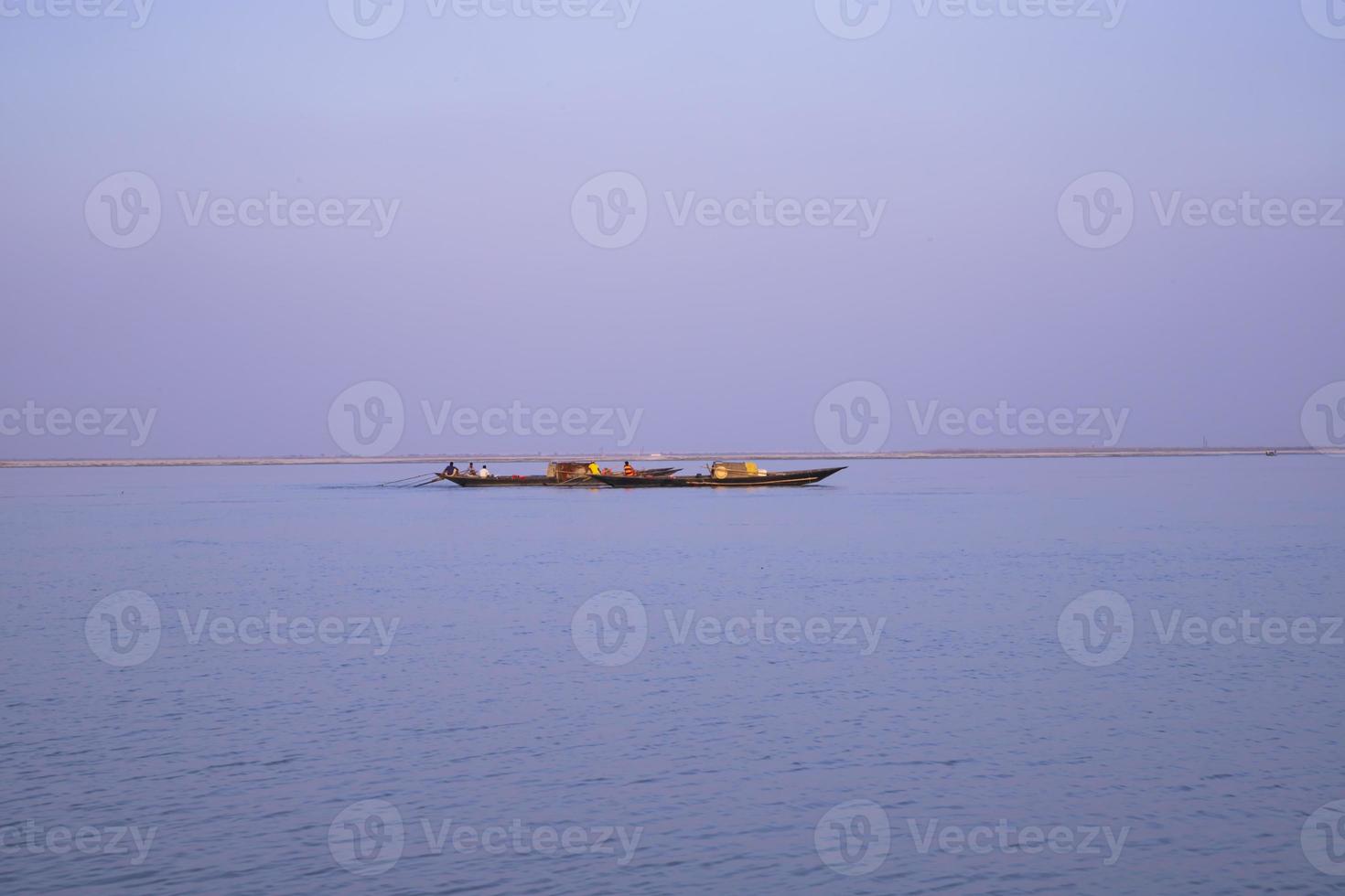 Landscape View of a fishing boat on the  Padma river in Bangladesh photo