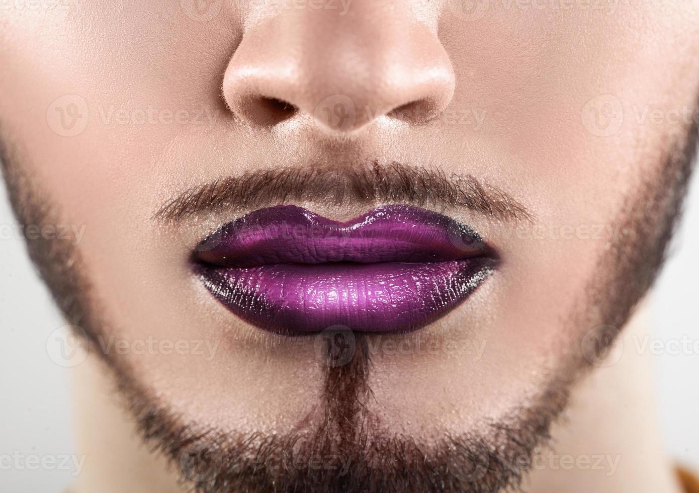 Macro photo of bearded male lips with makeup