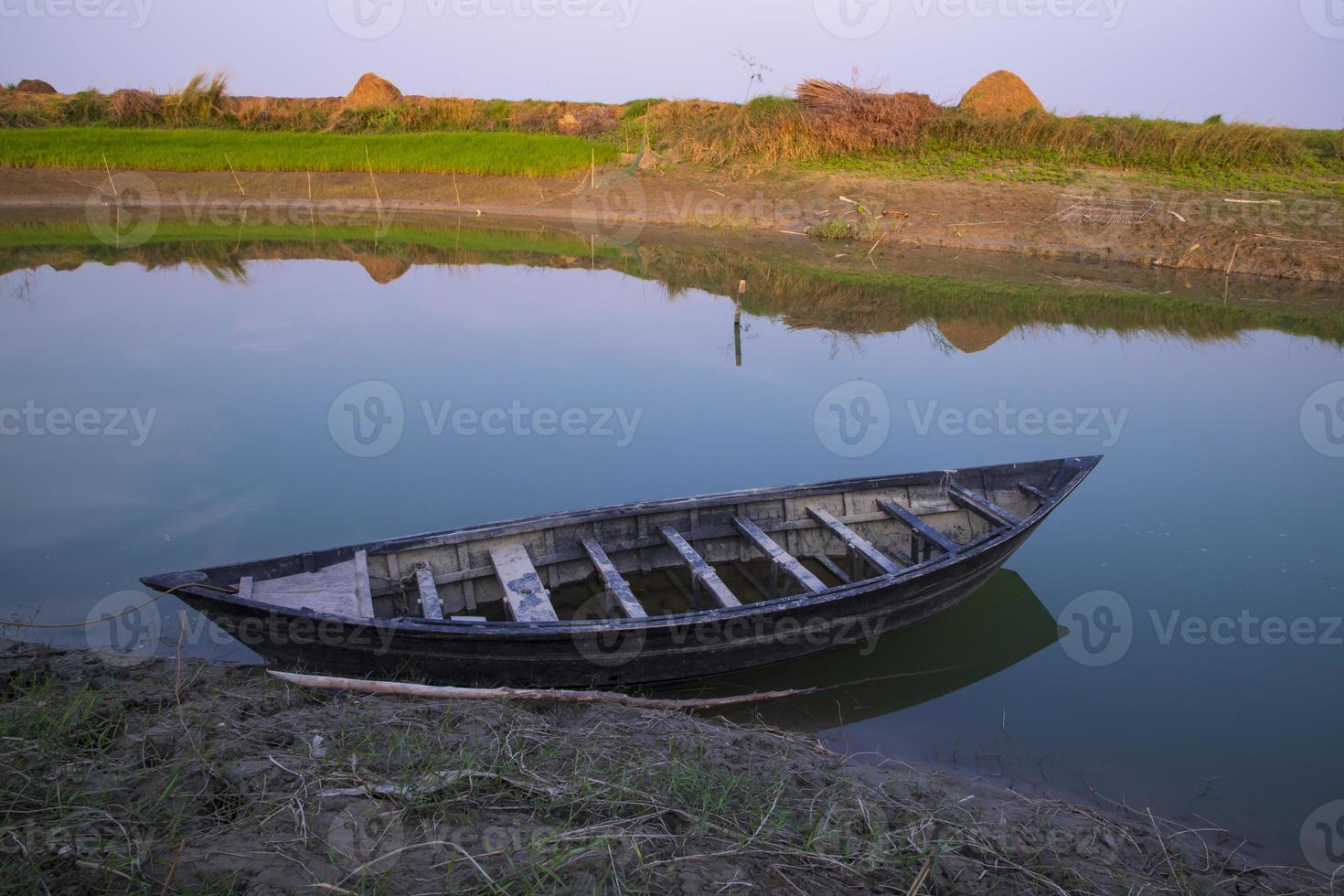 Landscape View of a wooden  boat on the bank of the Padma river in Bangladesh photo