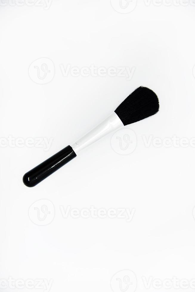 Black brush for cleaning optics. A small brush on a white background. A cleaning brush. photo