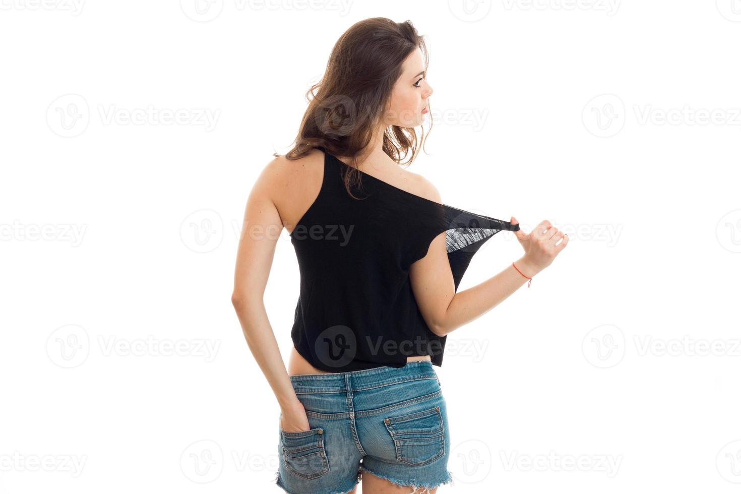 young brunette is worth turning your back to the camera in a black t-shirt photo