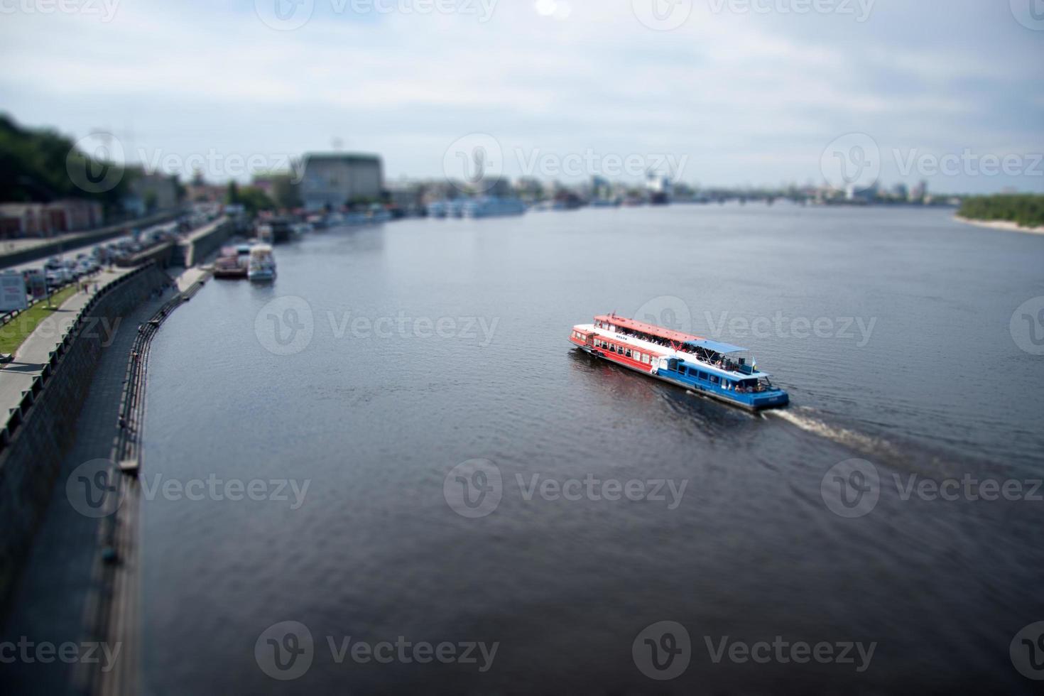 a passenger boat with people floats on the river, the effect of a micro-city. photo