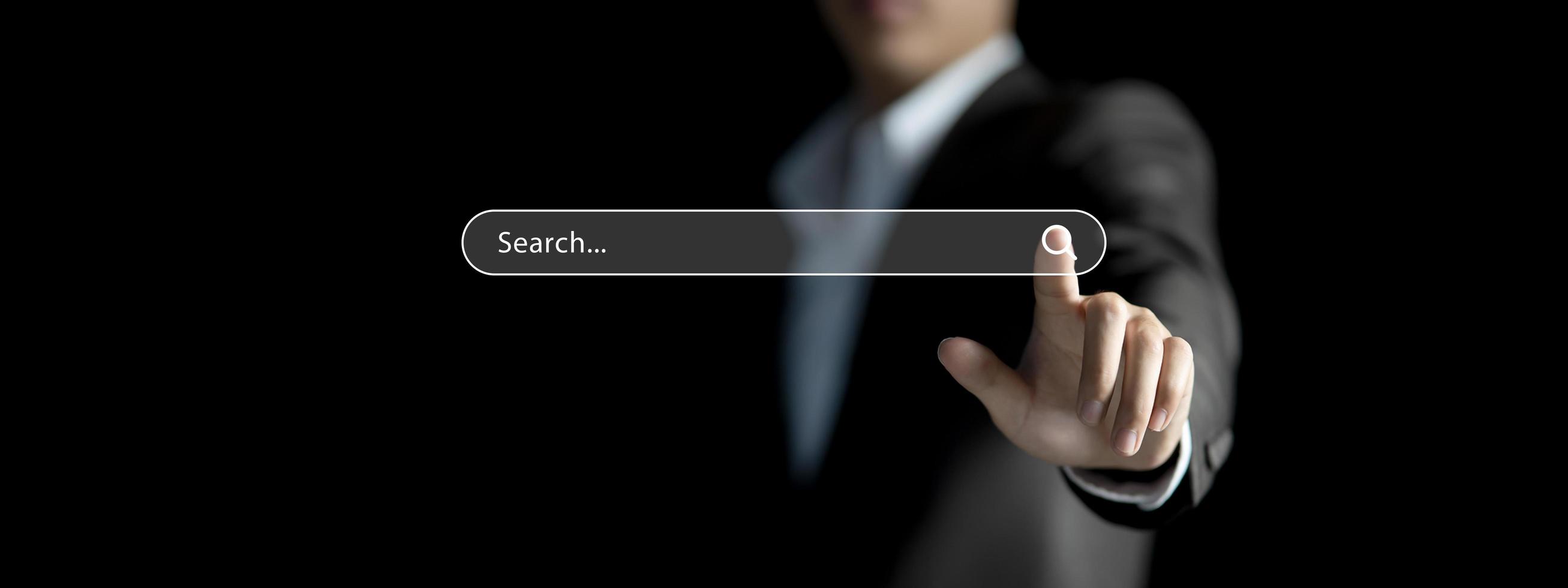 Businessman hand searching information on internet, Data search engine Optimization concept. Man's finger browsing internet connecting worldwide photo