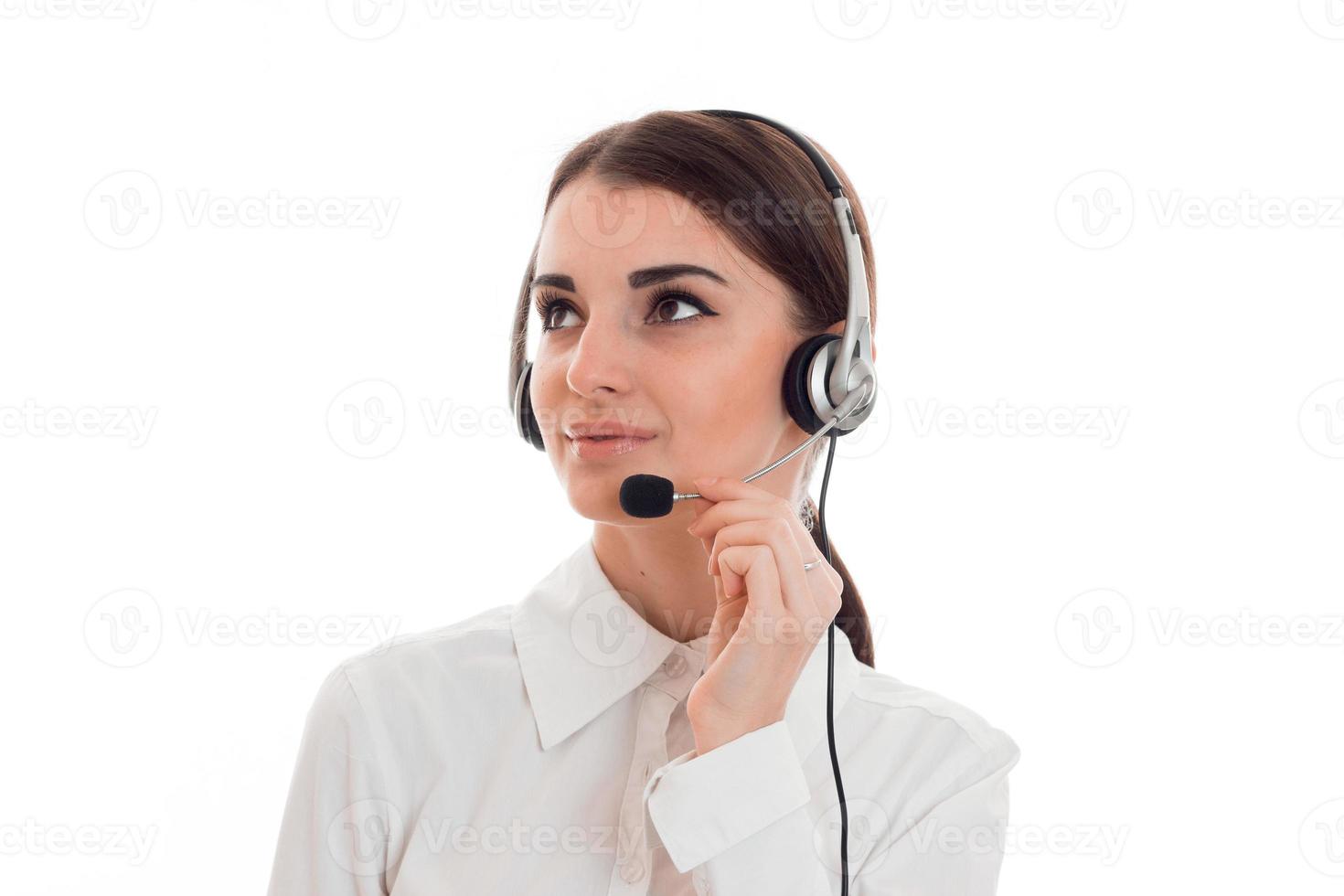 portrait of young beautiful call center worker girl with headphones and microphone posing isolated on white background photo