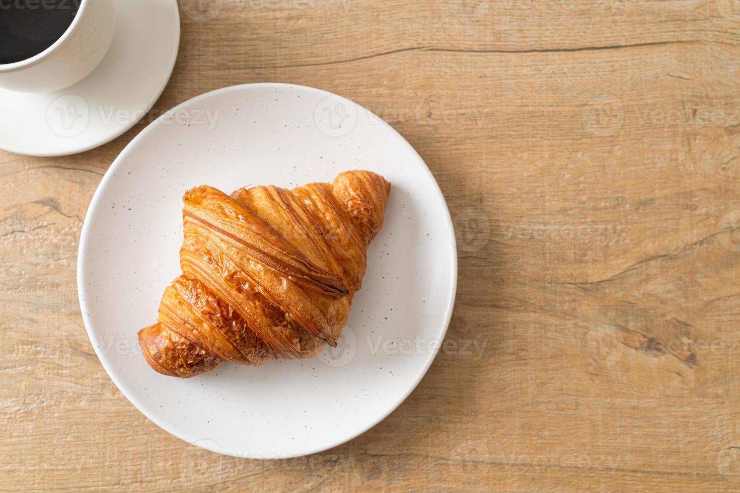 fresh croissant on white plate photo