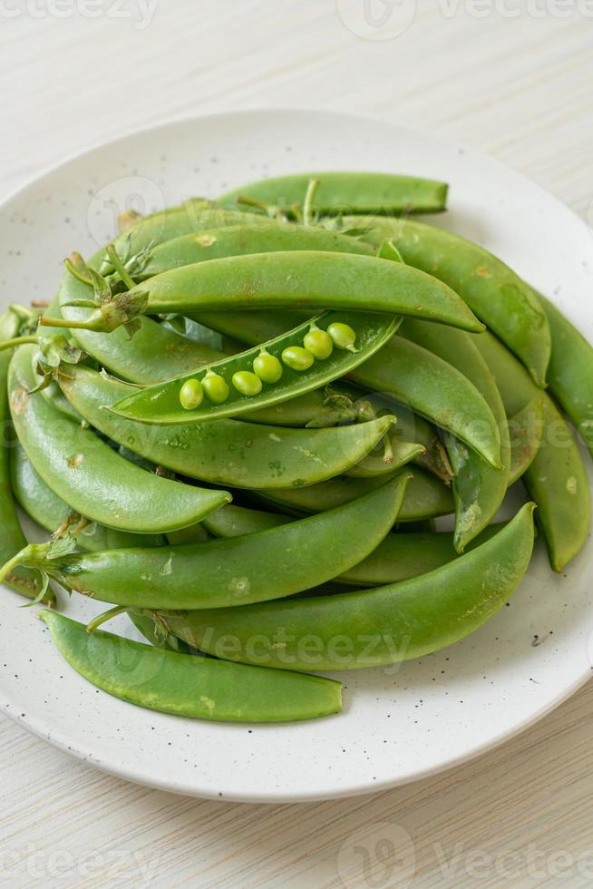 fresh sweet green peas on plate photo