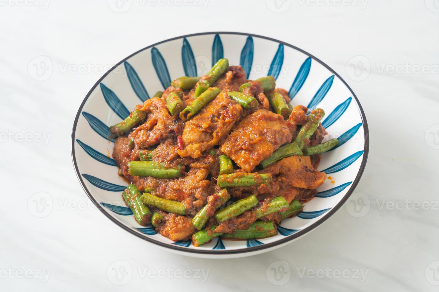 Stir fried pork with red curry paste photo