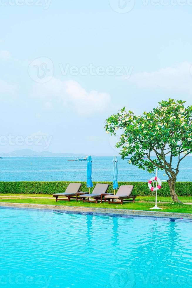 chair pool and umbrella around swimming pool photo