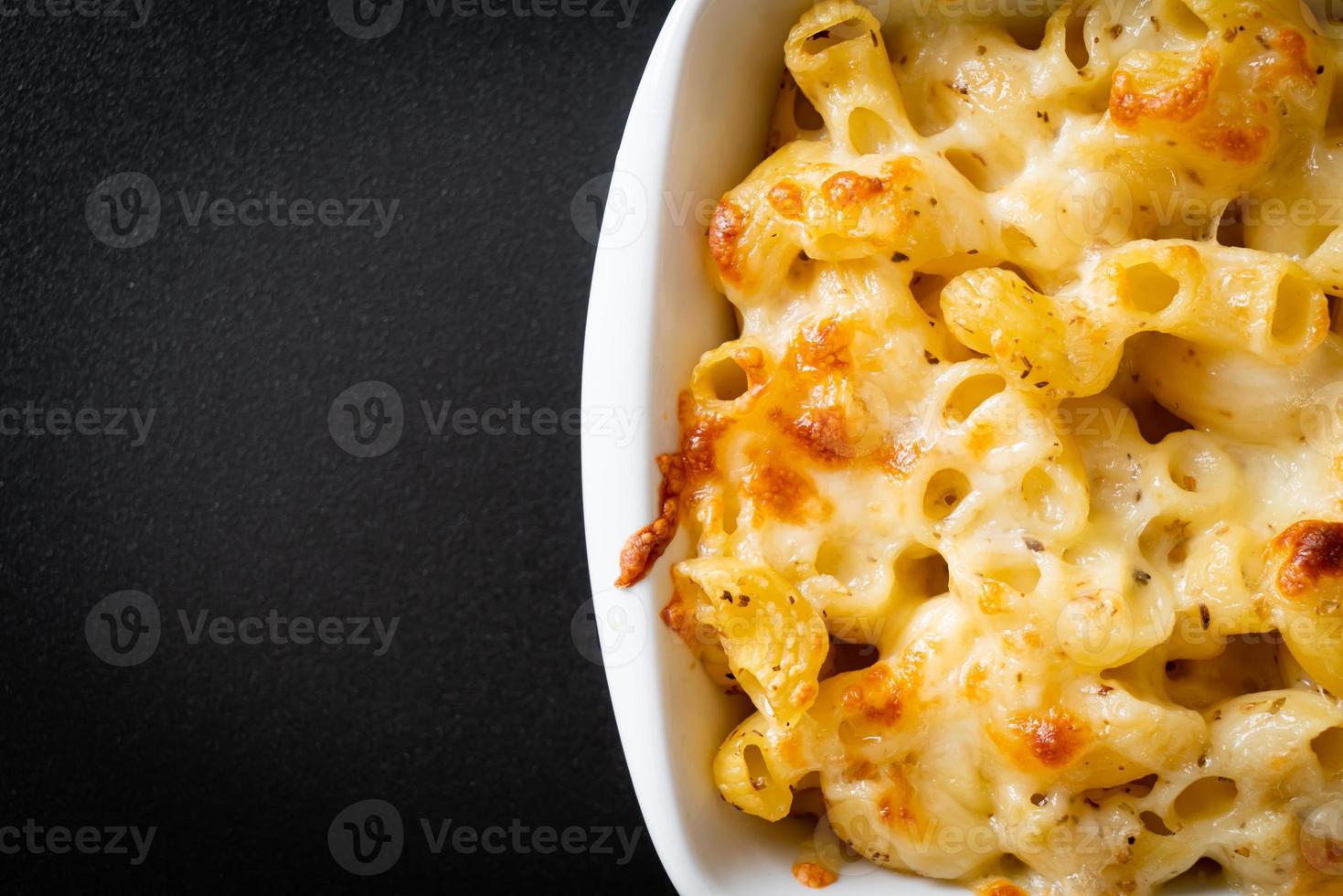 American mac and cheese, macaroni pasta in cheesy sauce photo