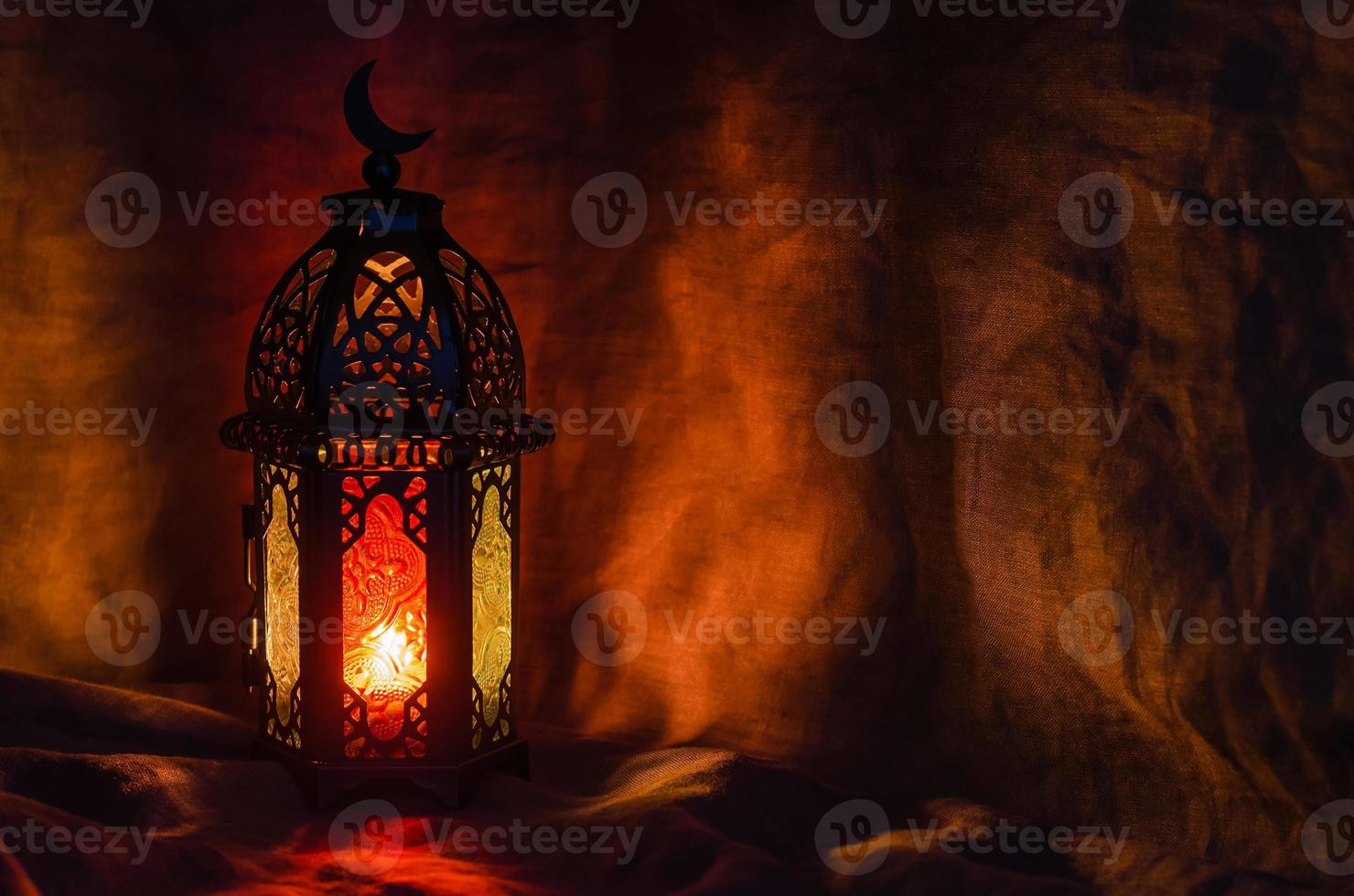 Black lantern on dark background for the Muslim feast of the holy month of Ramadan Kareem. photo
