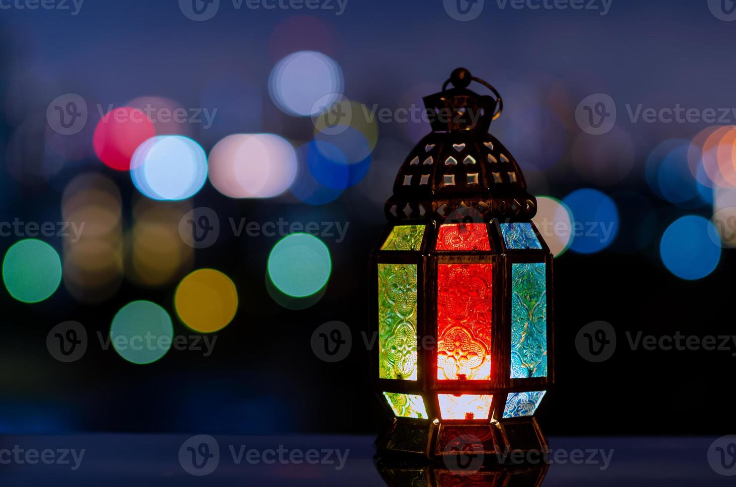 Lantern with night sky and city bokeh light background for the Muslim feast of the holy month of Ramadan Kareem. photo