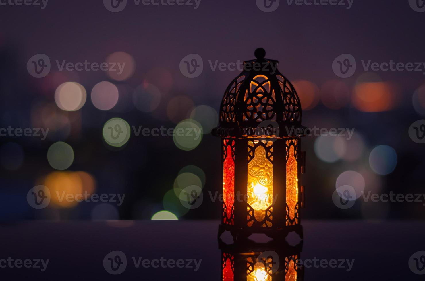 Lantern with night sky and city bokeh light background for the Muslim feast of the holy month of Ramadan Kareem. photo