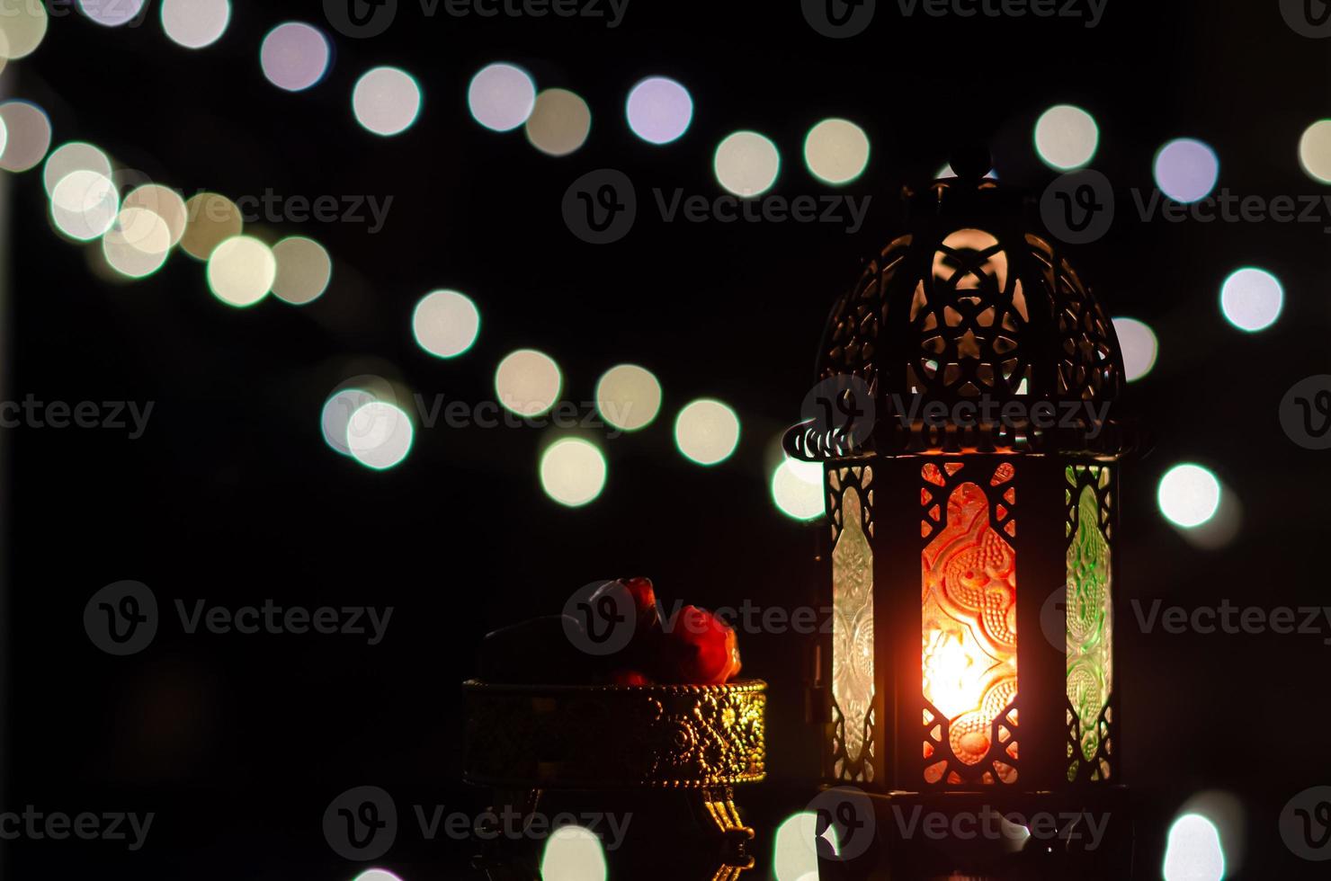 Lantern and dates fruit with bokeh light in dark background for the Muslim feast of the holy month of Ramadan Kareem. photo