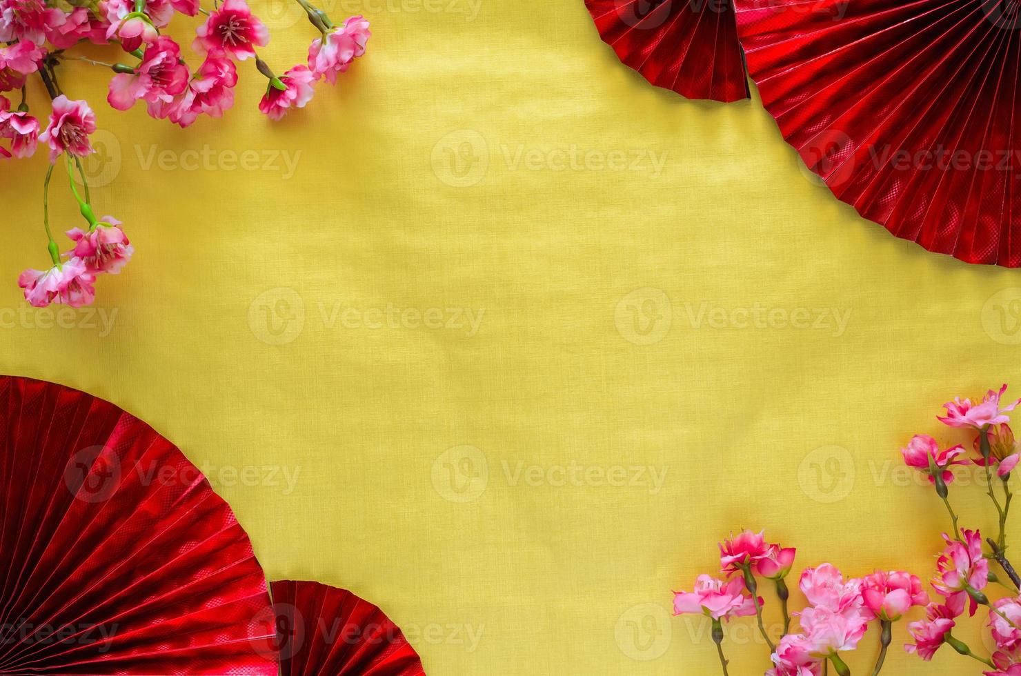 Chinese new year background concept with red oriental fans and cherry blossom on gold empty space background. photo