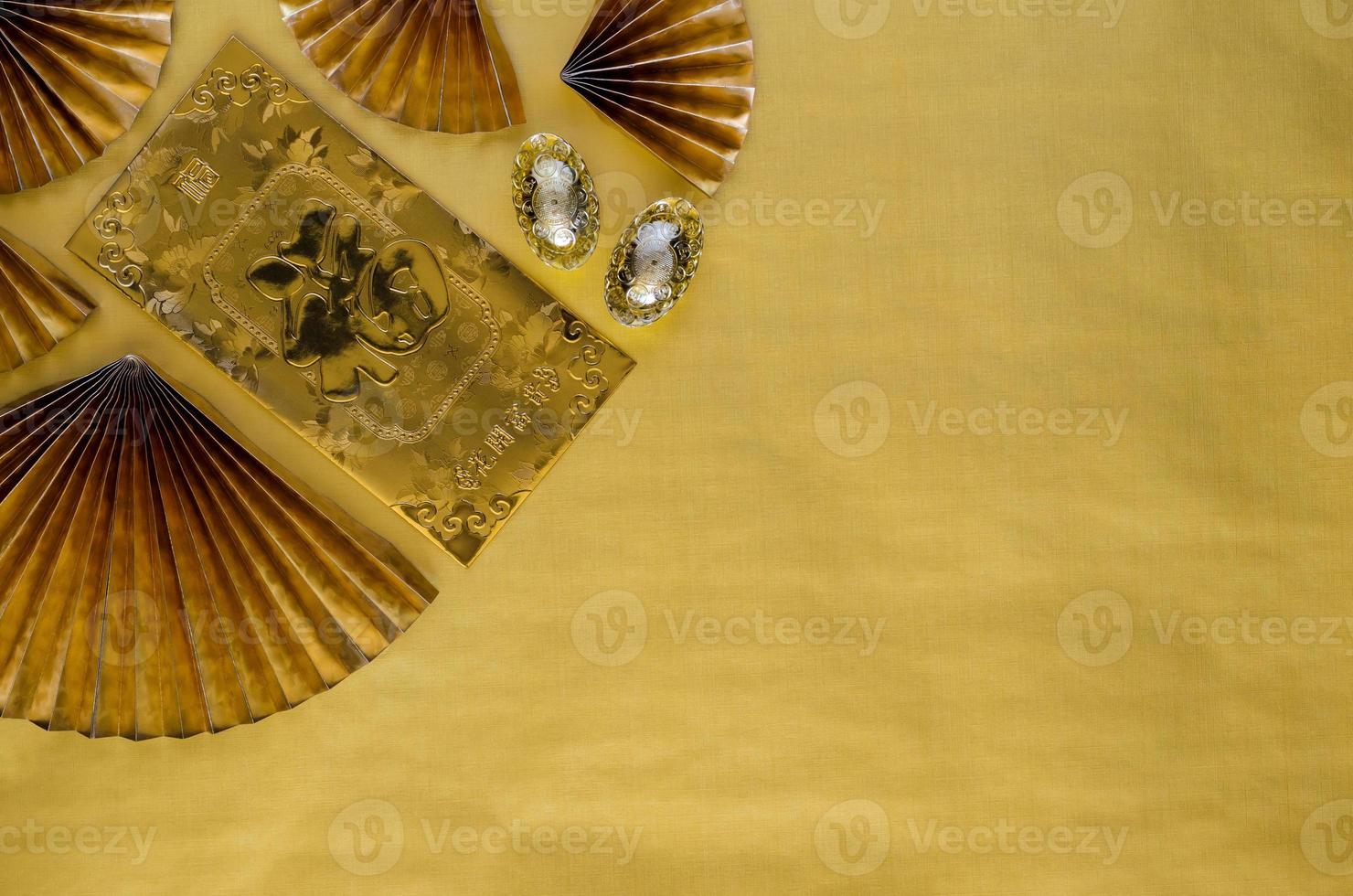 Chinese new year background concept with gold envelope packet or ang bao word mean wealth ingots and red oriental fans on gold empty space background. photo