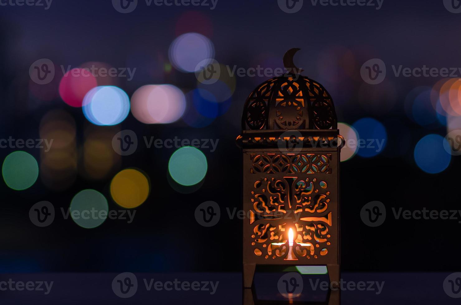 Lantern with night sky and city bokeh light background for the Muslim feast of the holy month of Ramadan Kareem. photo