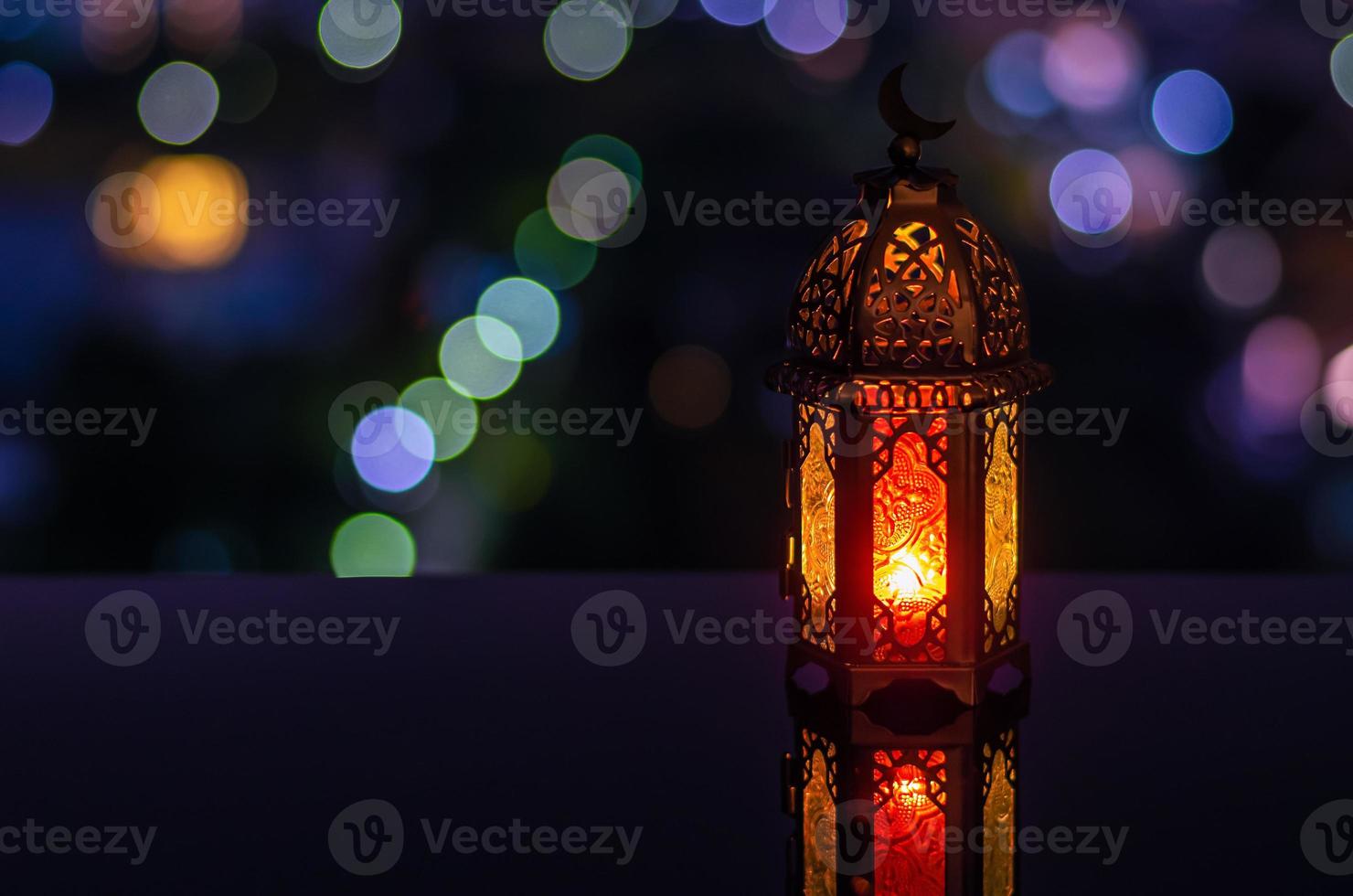 Lantern with night sky and city bokeh light background for the Muslim feast of the holy month of Ramadan Kareem. photo