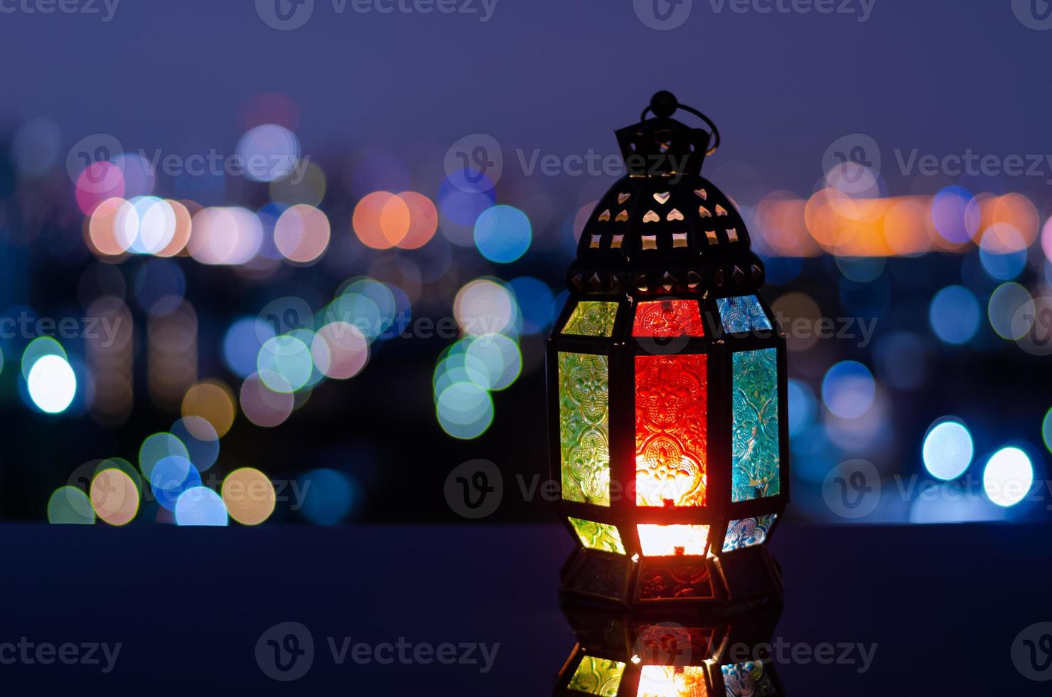 Lantern with night sky and city bokeh light background for the Muslim feast of the holy month of Ramadan Kareem. photo
