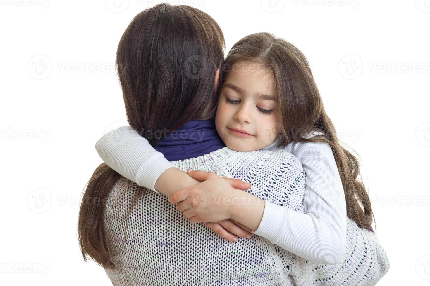 mom hugs her little daughter photo