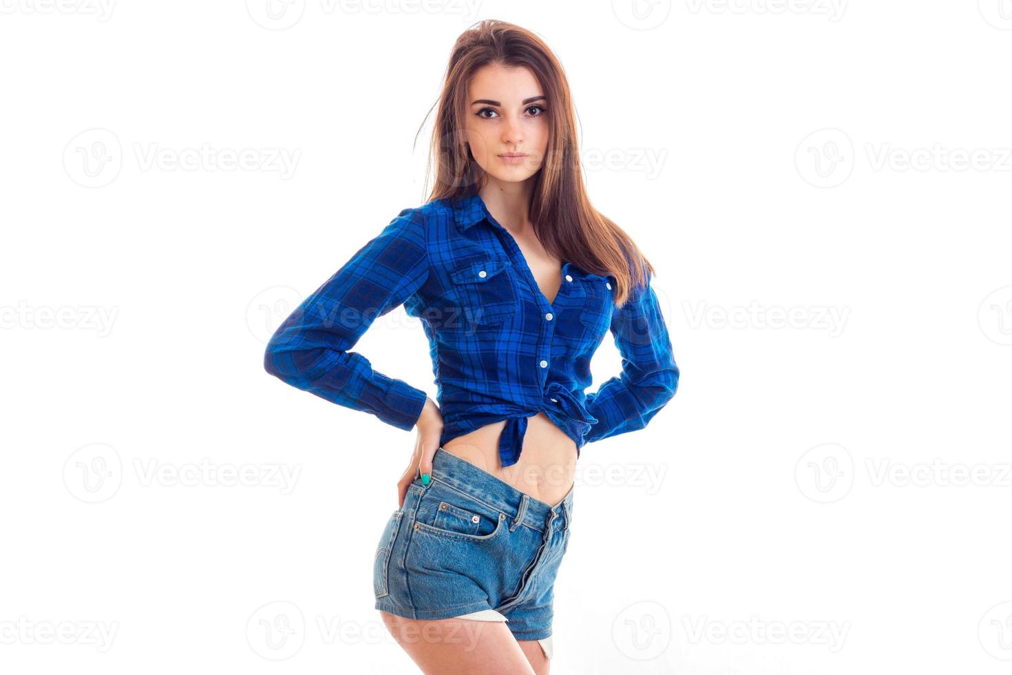 beautiful brunette teen in a Plaid Shirt and denim shorts posing for the camera photo