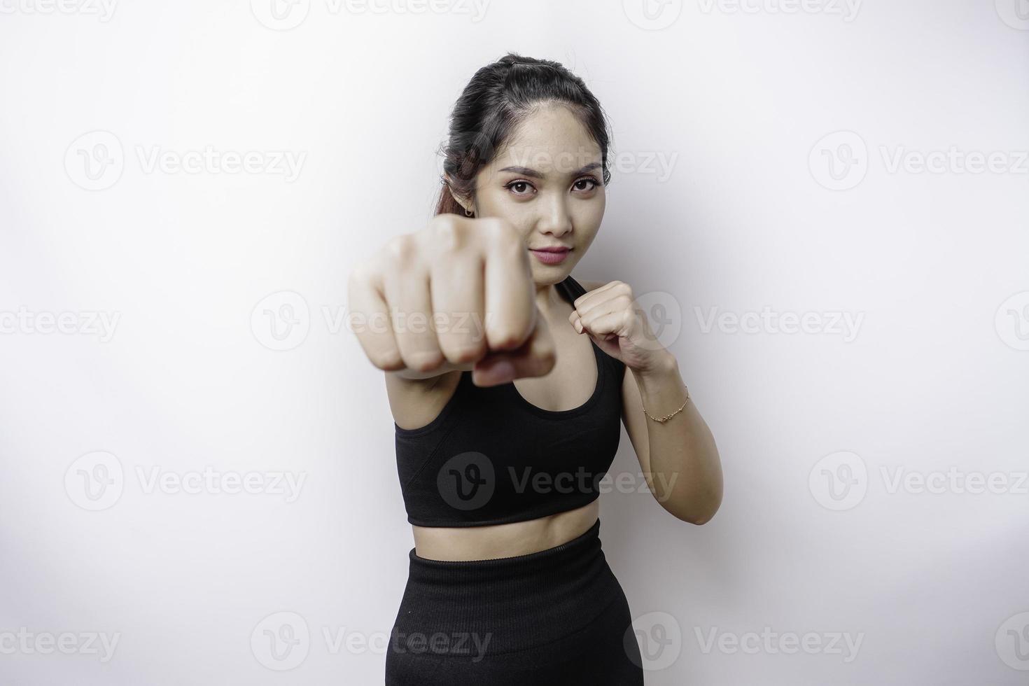 Beautiful sporty Asian woman fighter trains boxing in studio on white background. Martial arts concept photo