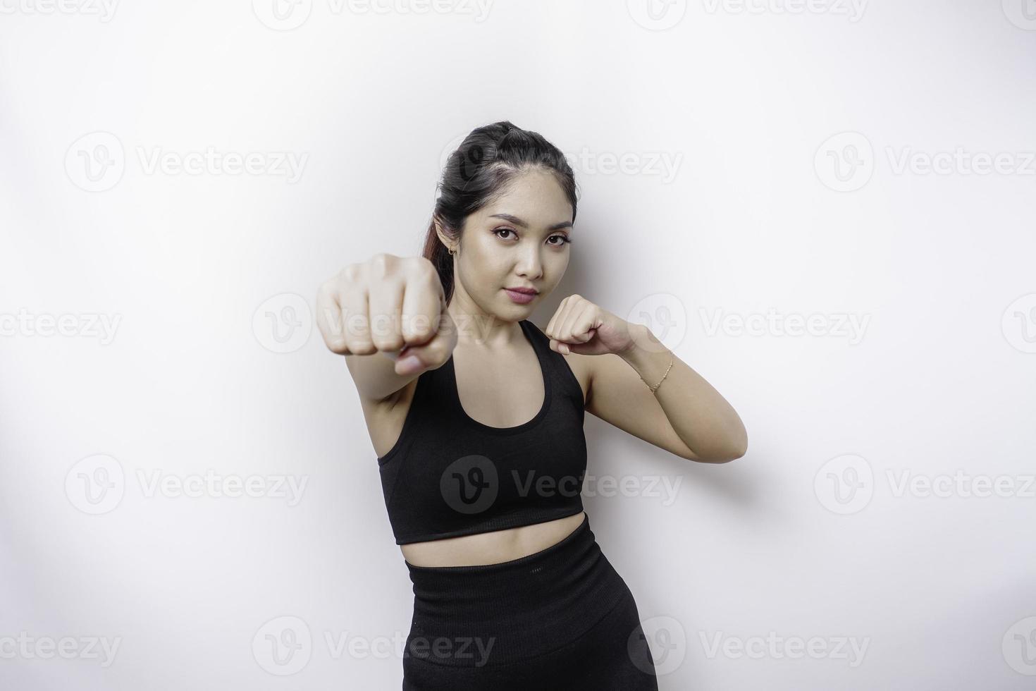 Beautiful sporty Asian woman fighter trains boxing in studio on white background. Martial arts concept photo