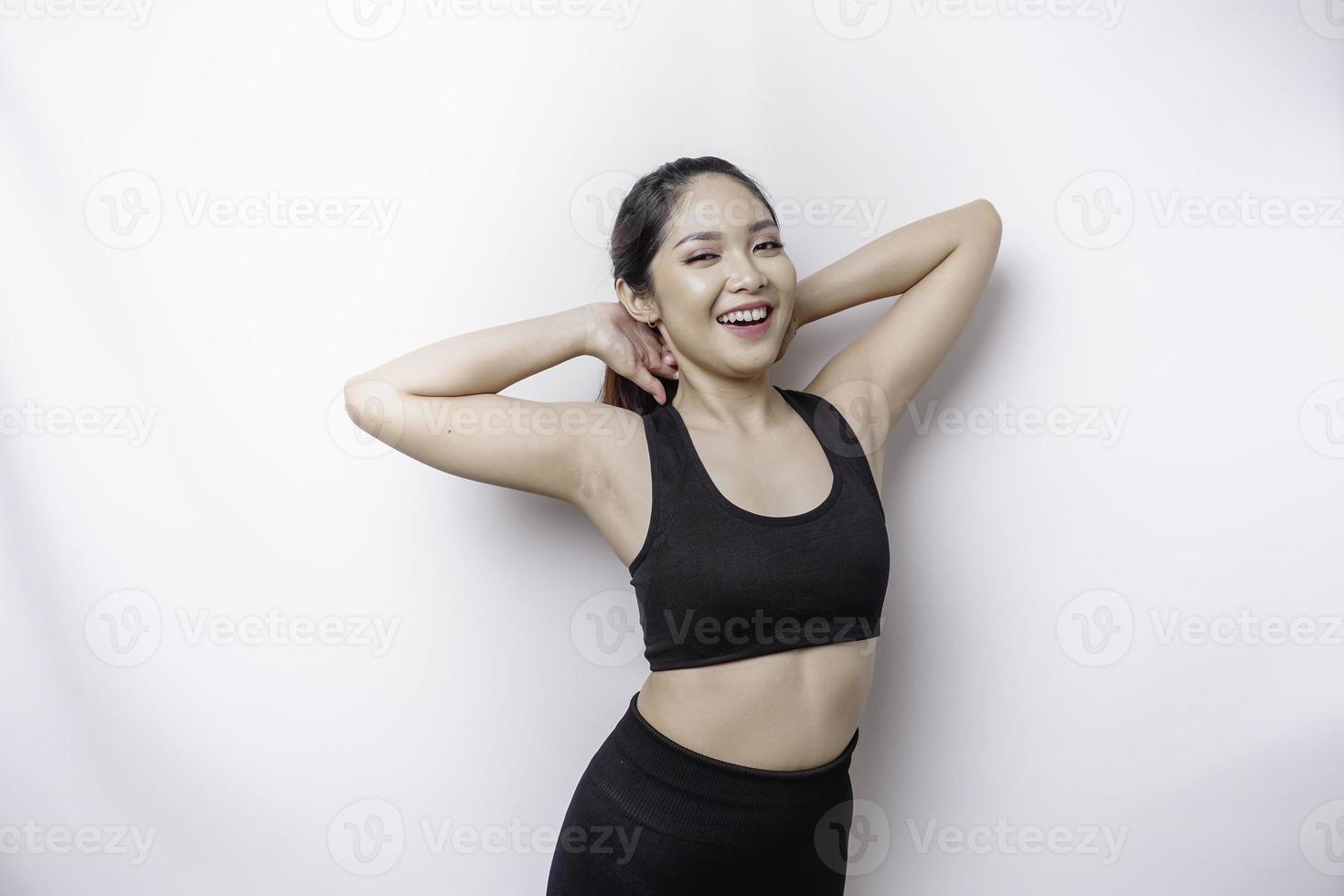 Portrait of young Asian sporty woman wearing sportswear is stretching out before training. photo
