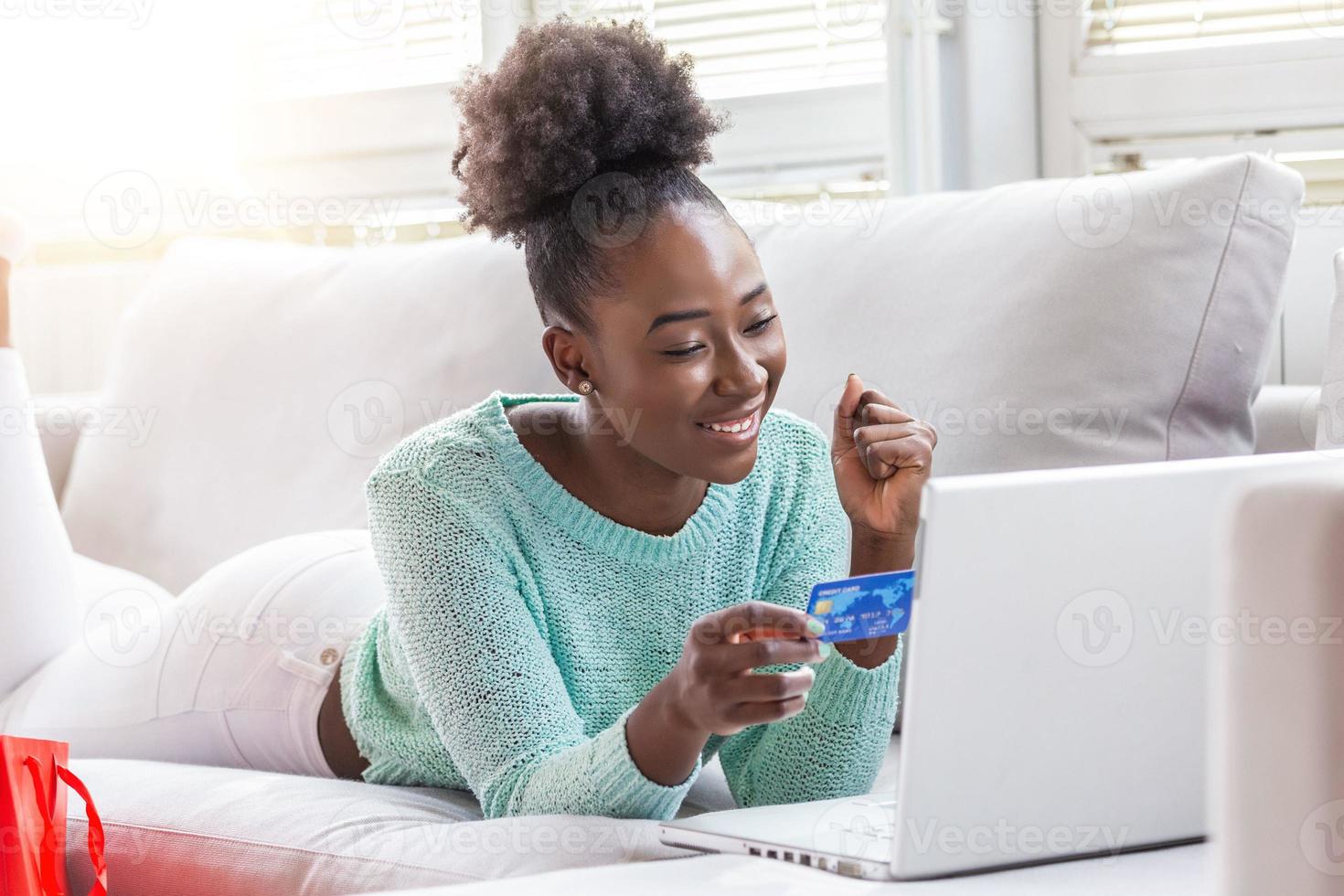 Young beautiful woman happy for finding shopping items for sale online. Beautiful girl using laptop computer for online shopping at home photo