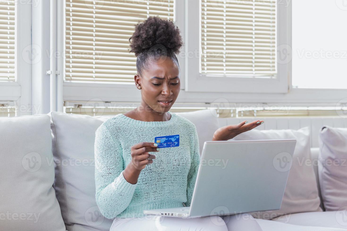 Confused young woman having problem with blocked credit card making rejected unsecure online payment using laptop at home, invalid expired account, transaction failed, money withdraw impossible, debt photo