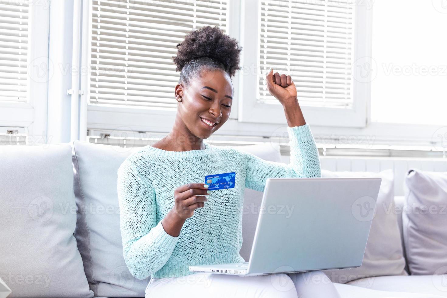 Young beautiful woman happy for finding shopping items for sale online. Beautiful girl using laptop computer for online shopping at home photo