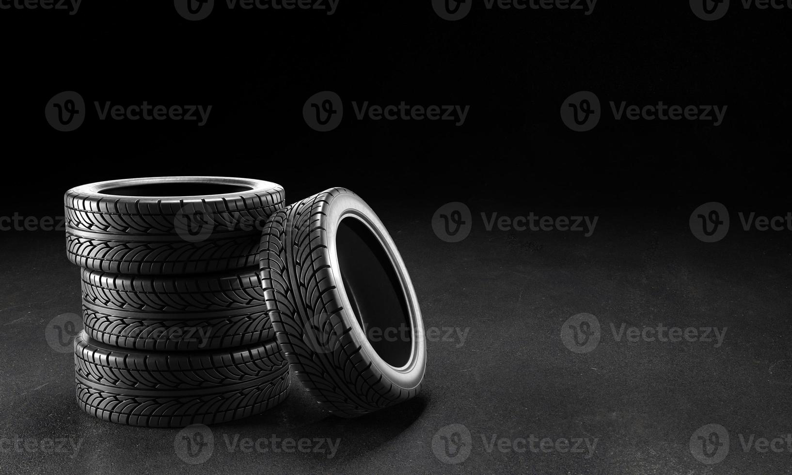 Four car tires on the asphalt on a black background. 3D rendering illustration. photo