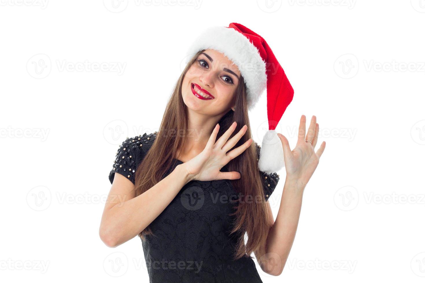 cheerful brunette girl in santa hat photo
