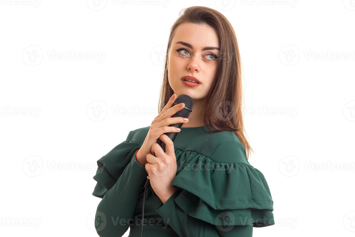 charming woman in green color dress with microphone photo
