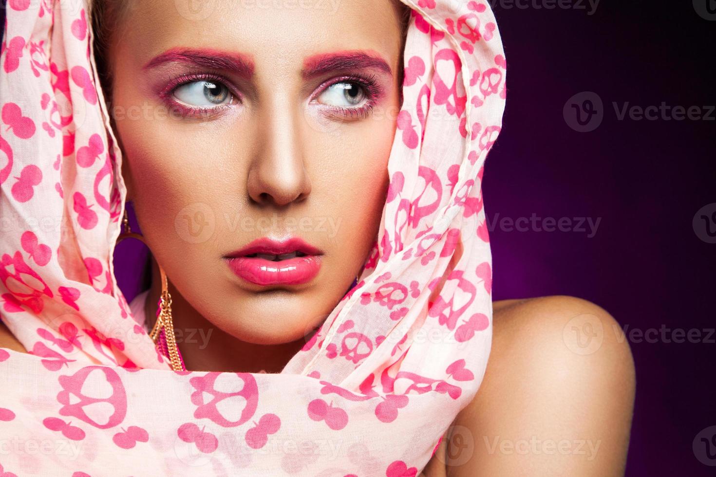 Portrait of female in scarf on purple background photo