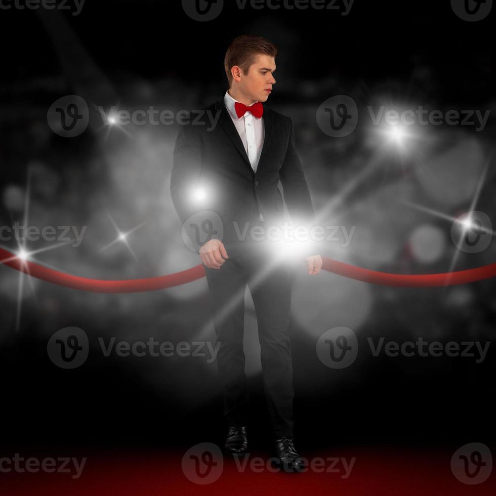 guy in a suit goes on the red carpet photo