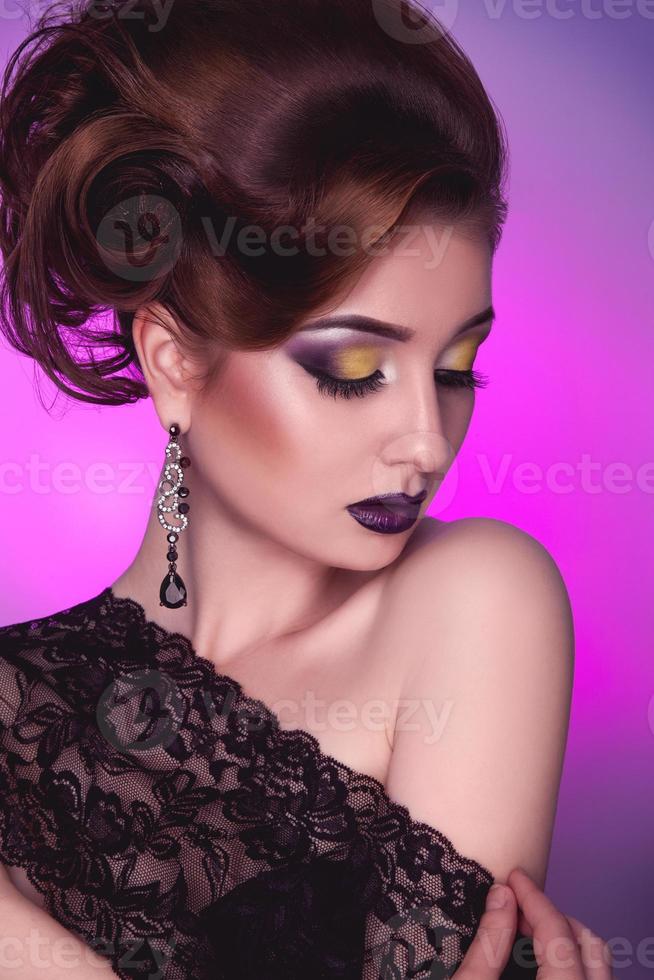 Vertical photo of elegance adult girl with creative hairstyle and make up on pink background