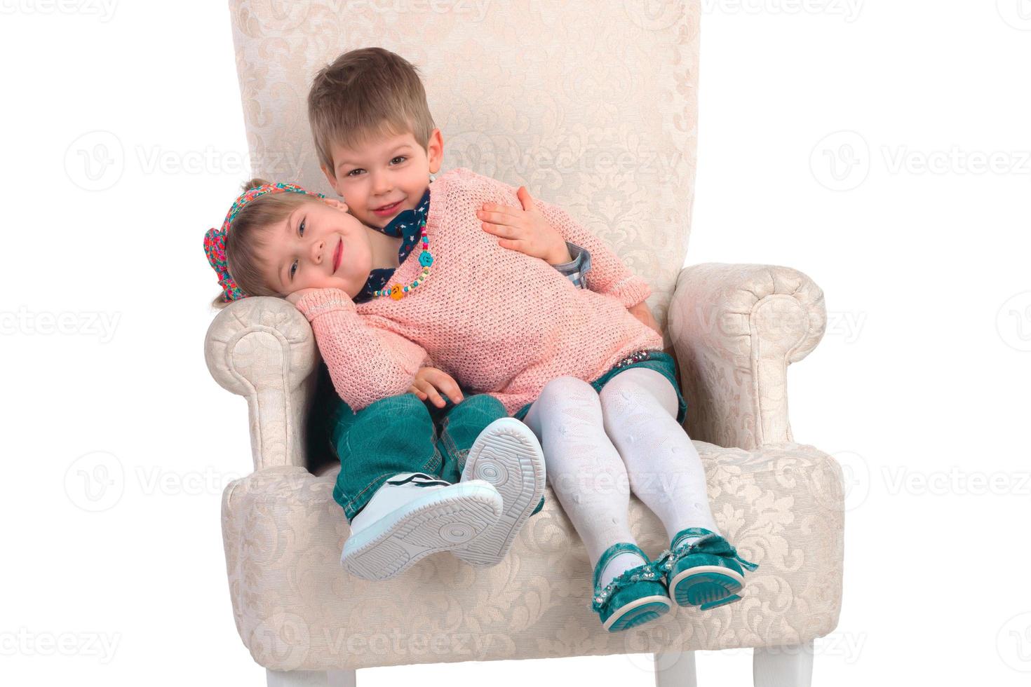 Children sit in a chair photo
