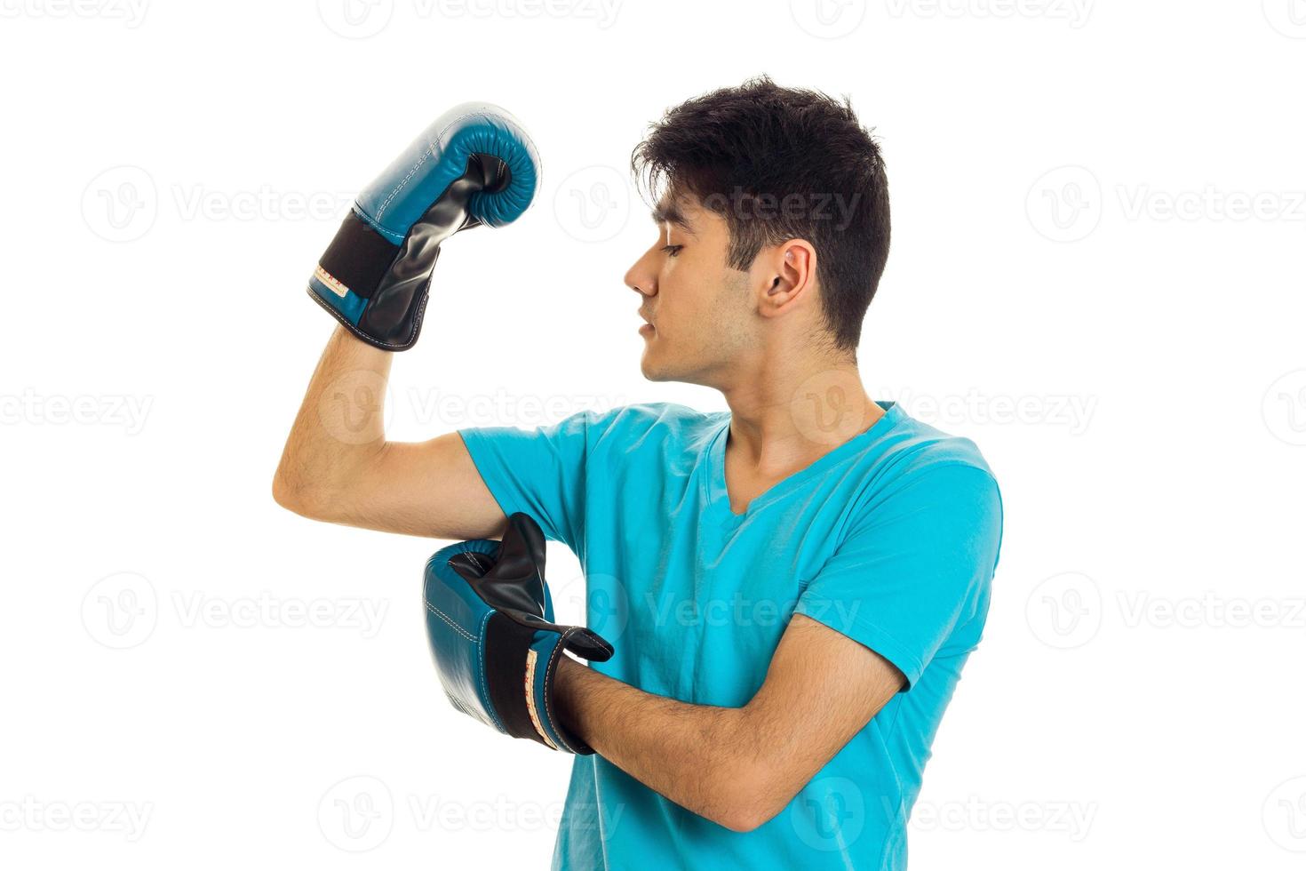 portrait of powerful brunette sports man practicing box in blue gloves isolated on white background photo