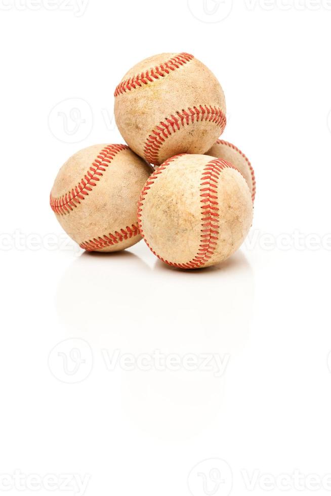 Four Baseballs Isolated on Reflective White photo